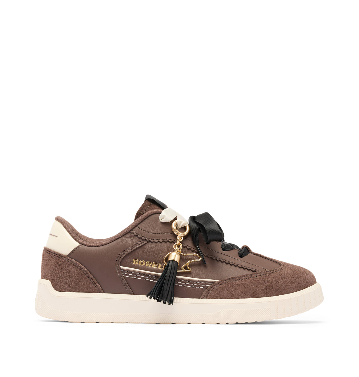 A brown suede and leather low-top sneaker by Boreli, featuring a cream-colored sole, a black ribbon lacing system, and a decorative black tassel charm with a gold horse logo.