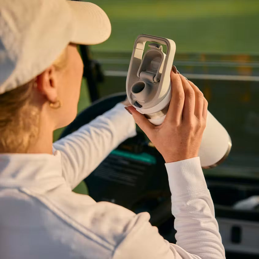 Person holding a car air freshener near a vehicle