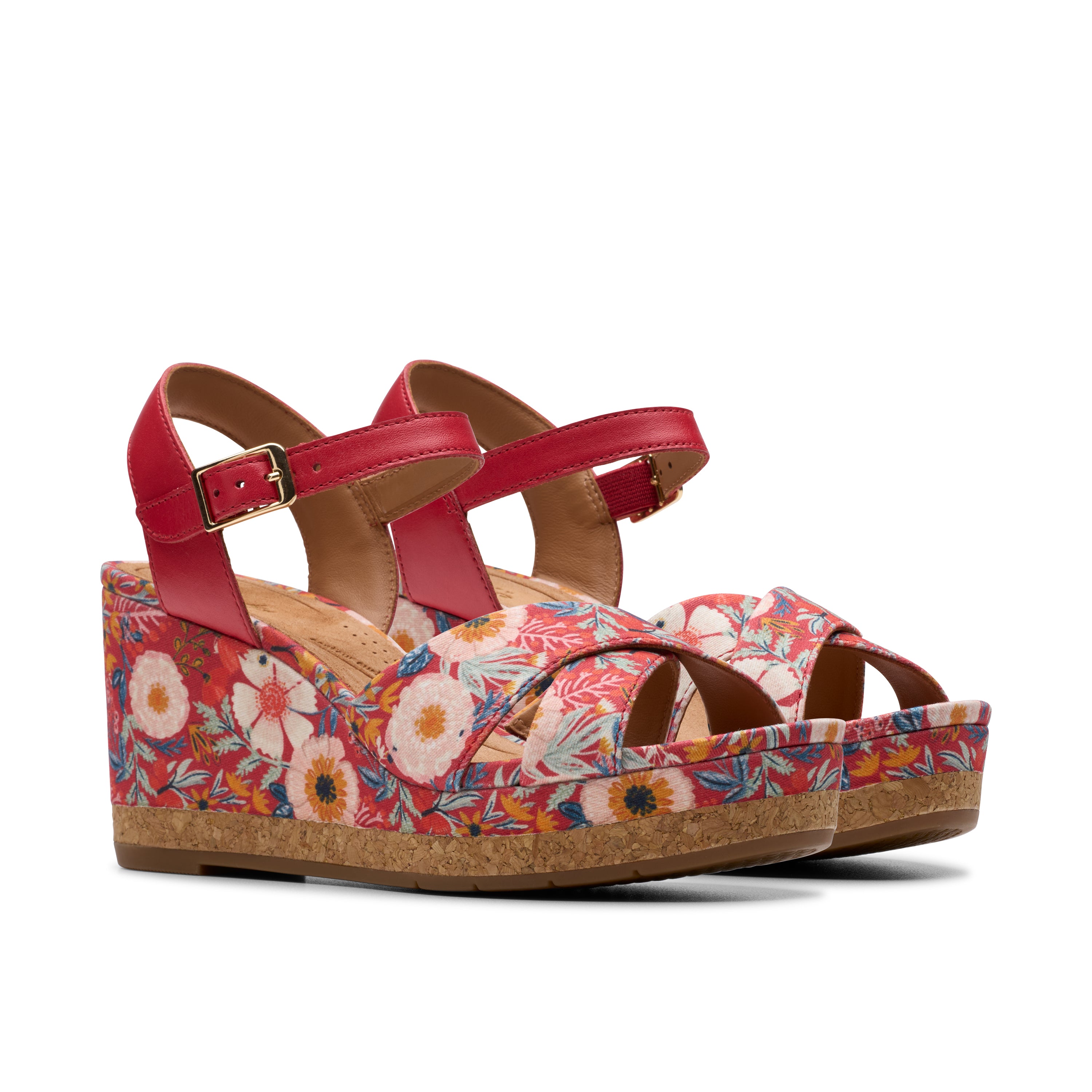 Red wedge sandals with floral pattern on a white background
