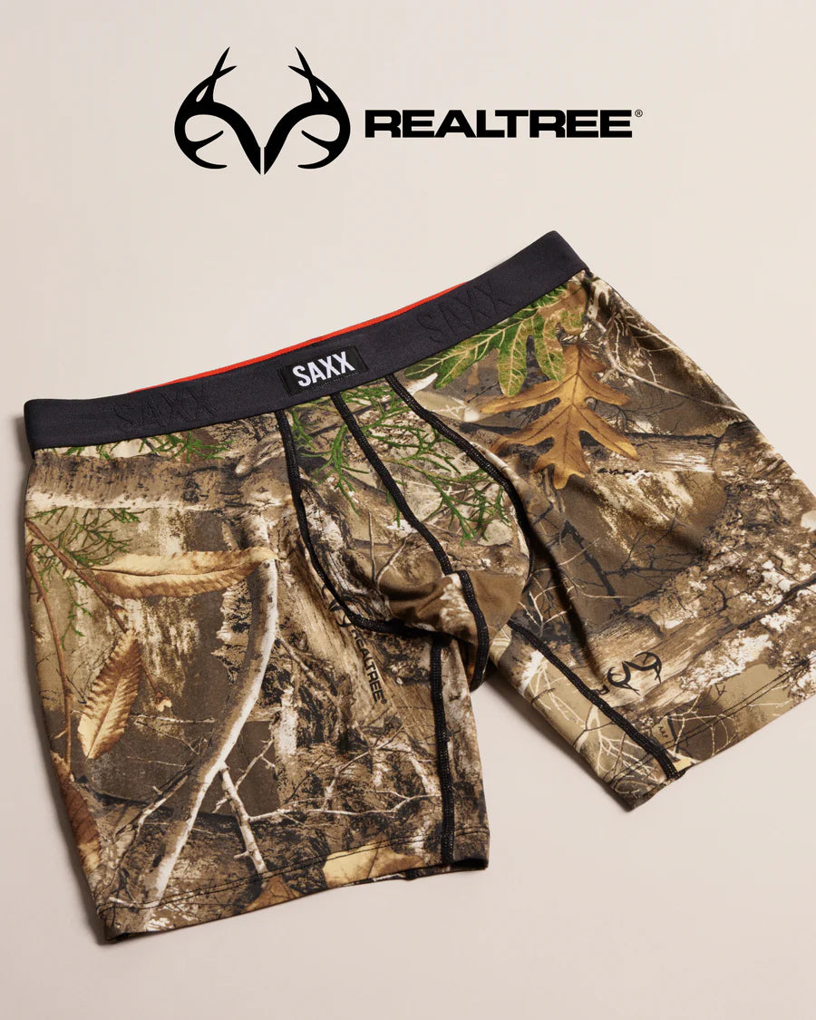 Camouflage underwear with 'SAXX' branding on a beige background, featuring the Realtree logo.