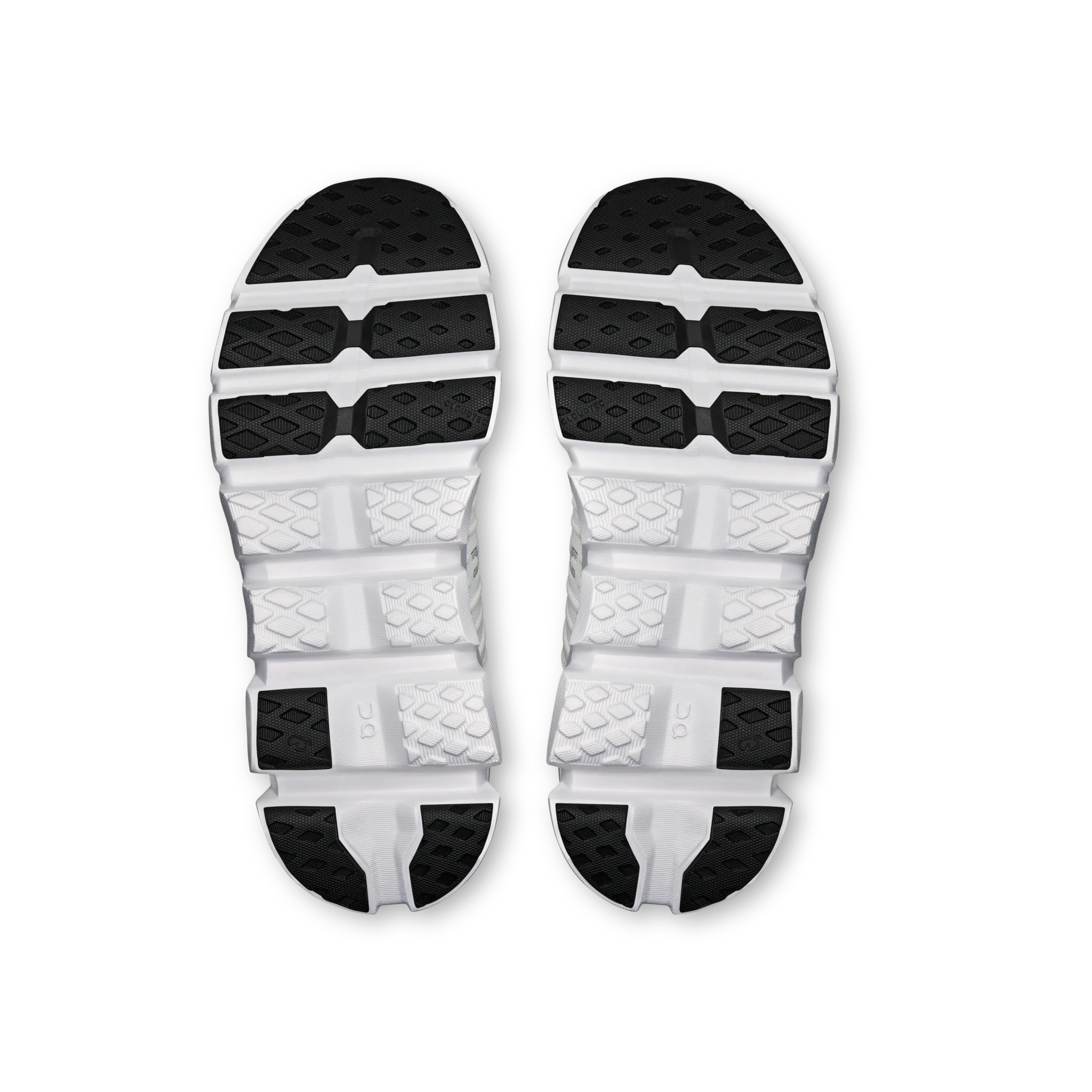 Top view of a pair of white athletic shoes with black soles on a white background