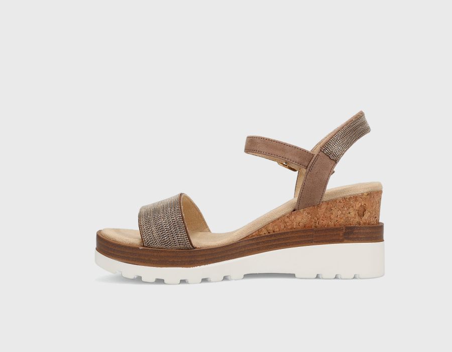 Brown sandal with cork sole on a light gray background