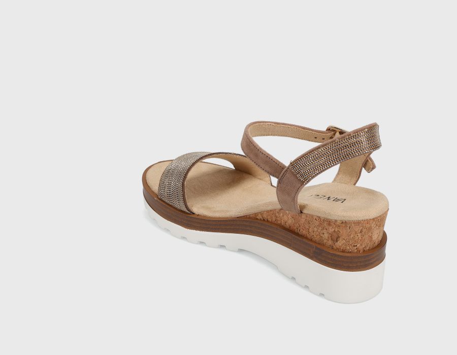 Brown sandal with cork wedge sole on a light gray background