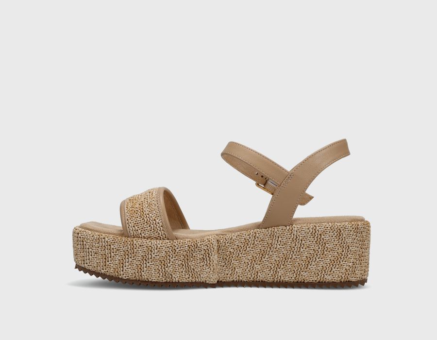 Beige sandal with textured sole on a white background
