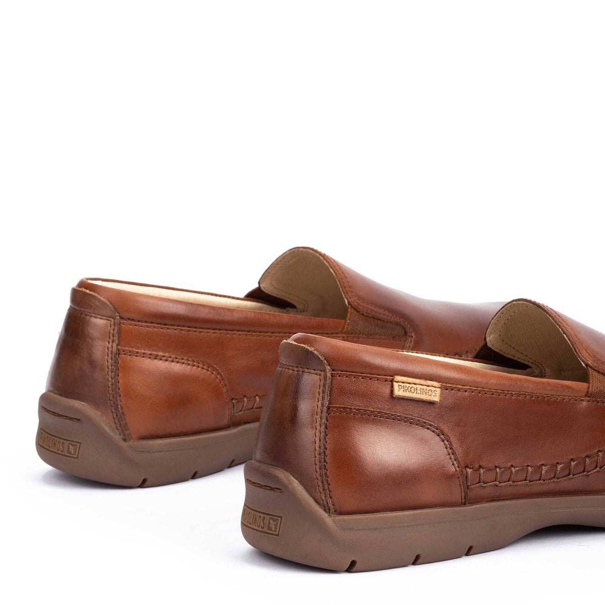 Pair of brown leather loafers on a white background
