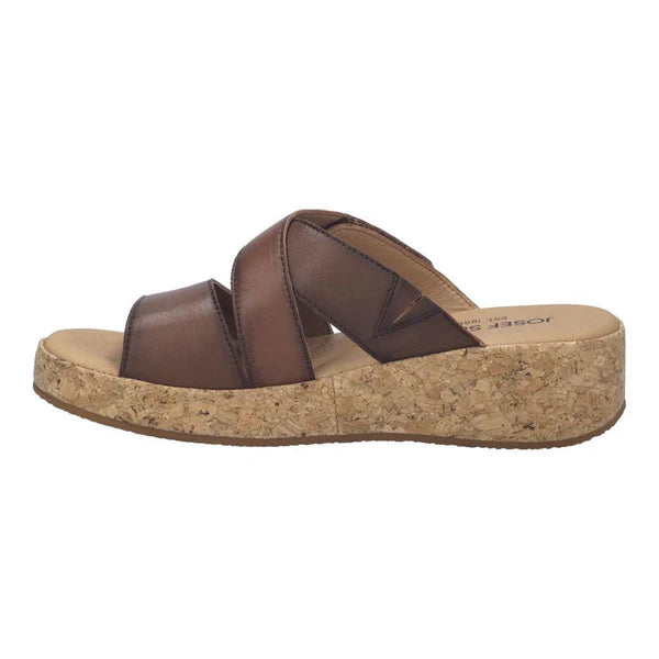 Brown sandal with cork wedge sole on a white background