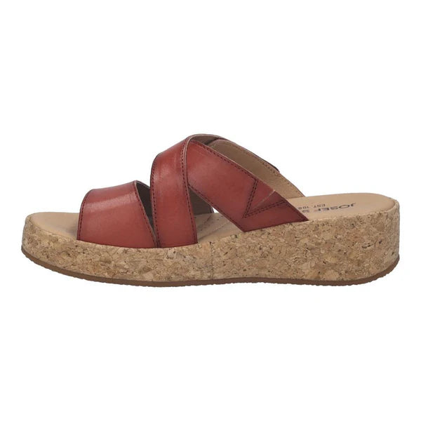 red sandal with cork wedge sole on a white background