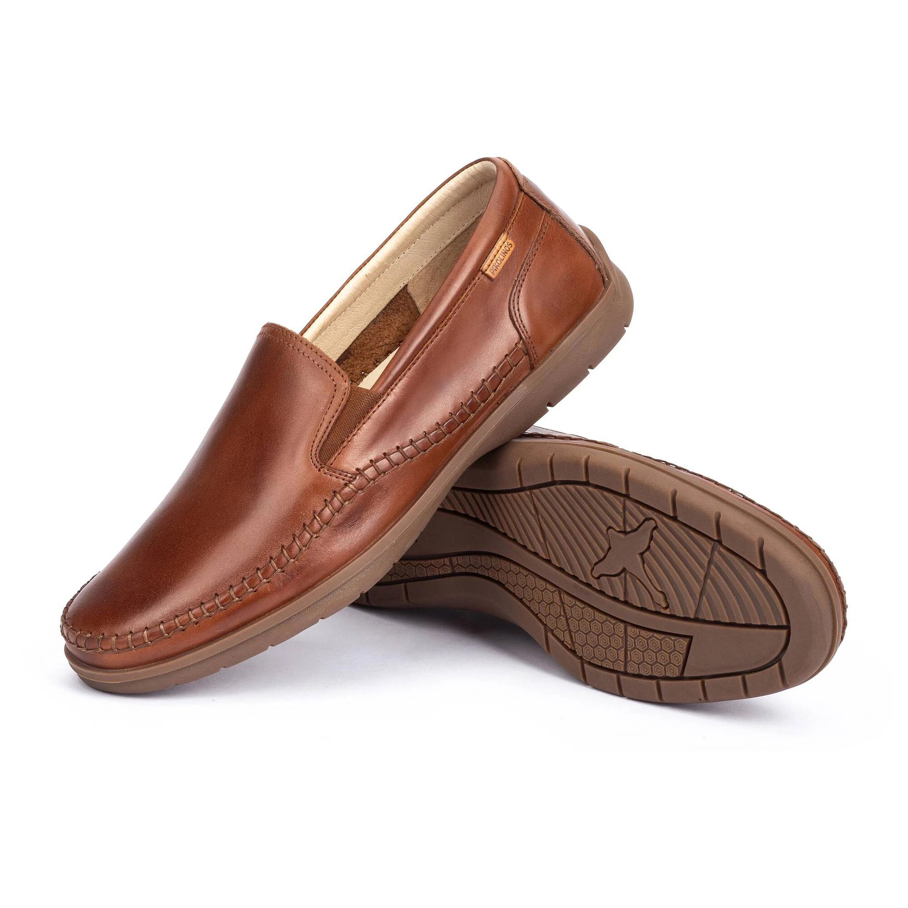 Brown leather loafers on a white background