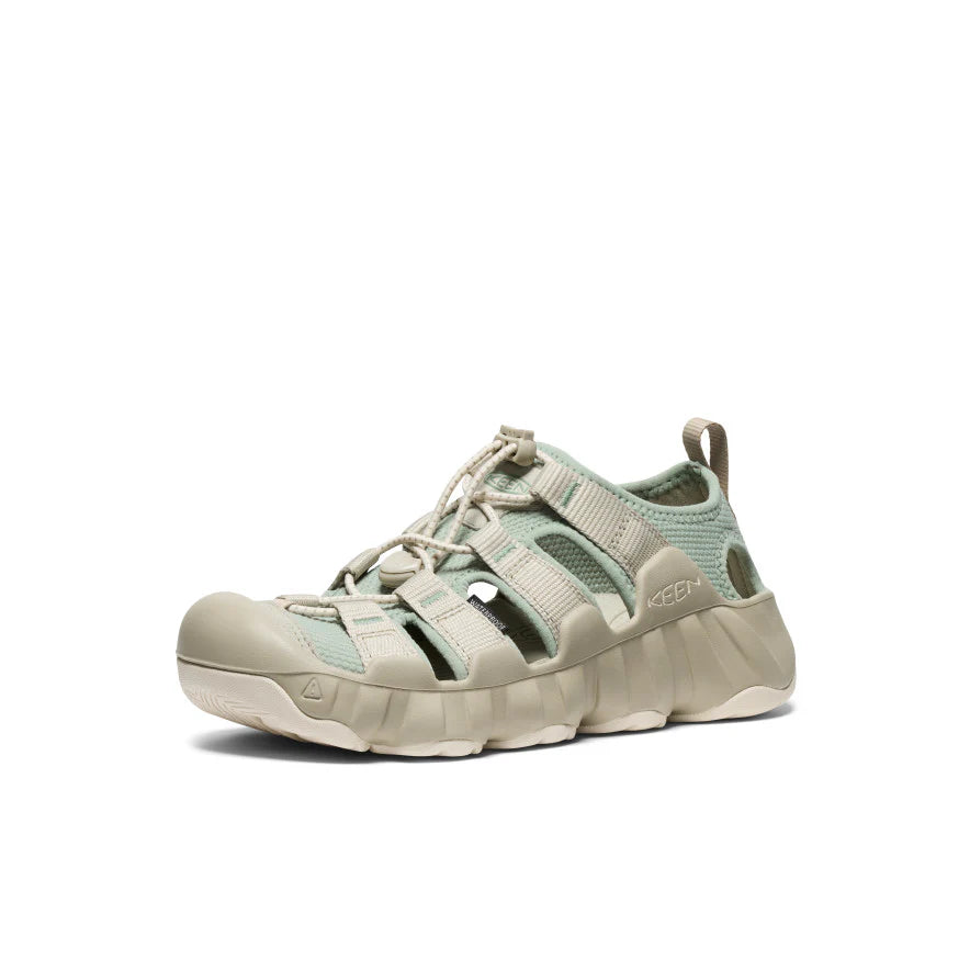 Light gray sandal with green accents on a white background