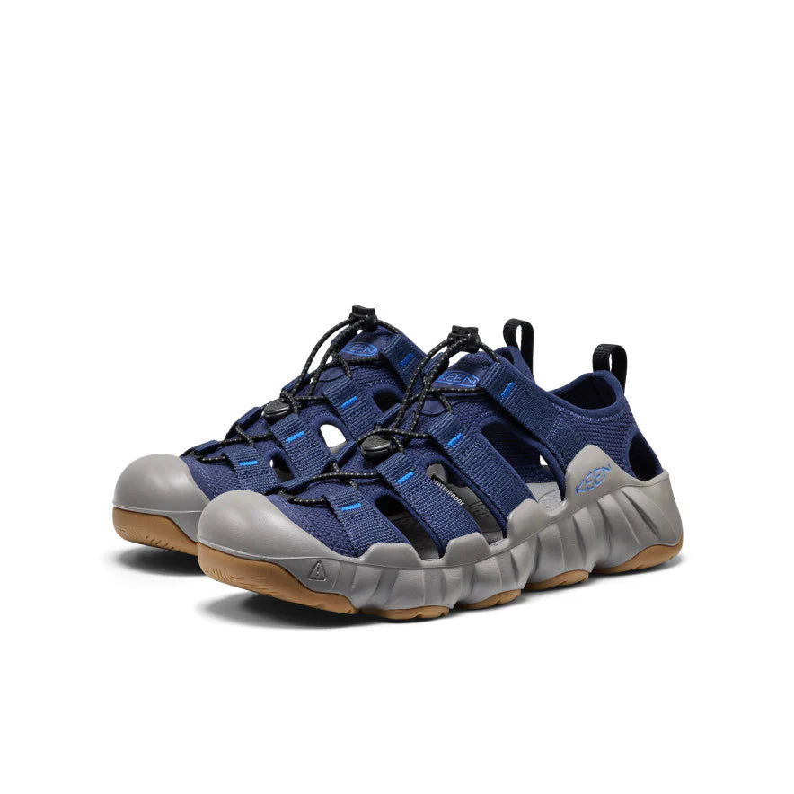 Blue and gray sandals with brown soles on a white background