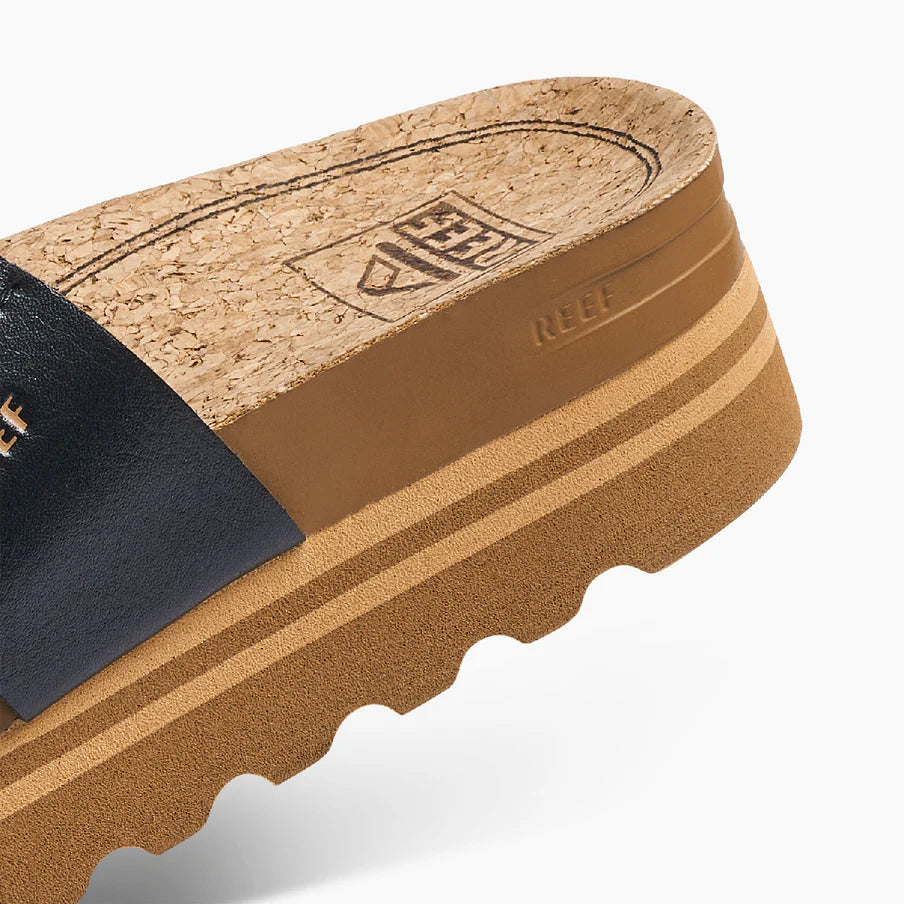 Close-up of a sandal with cork sole and black insole on a white background