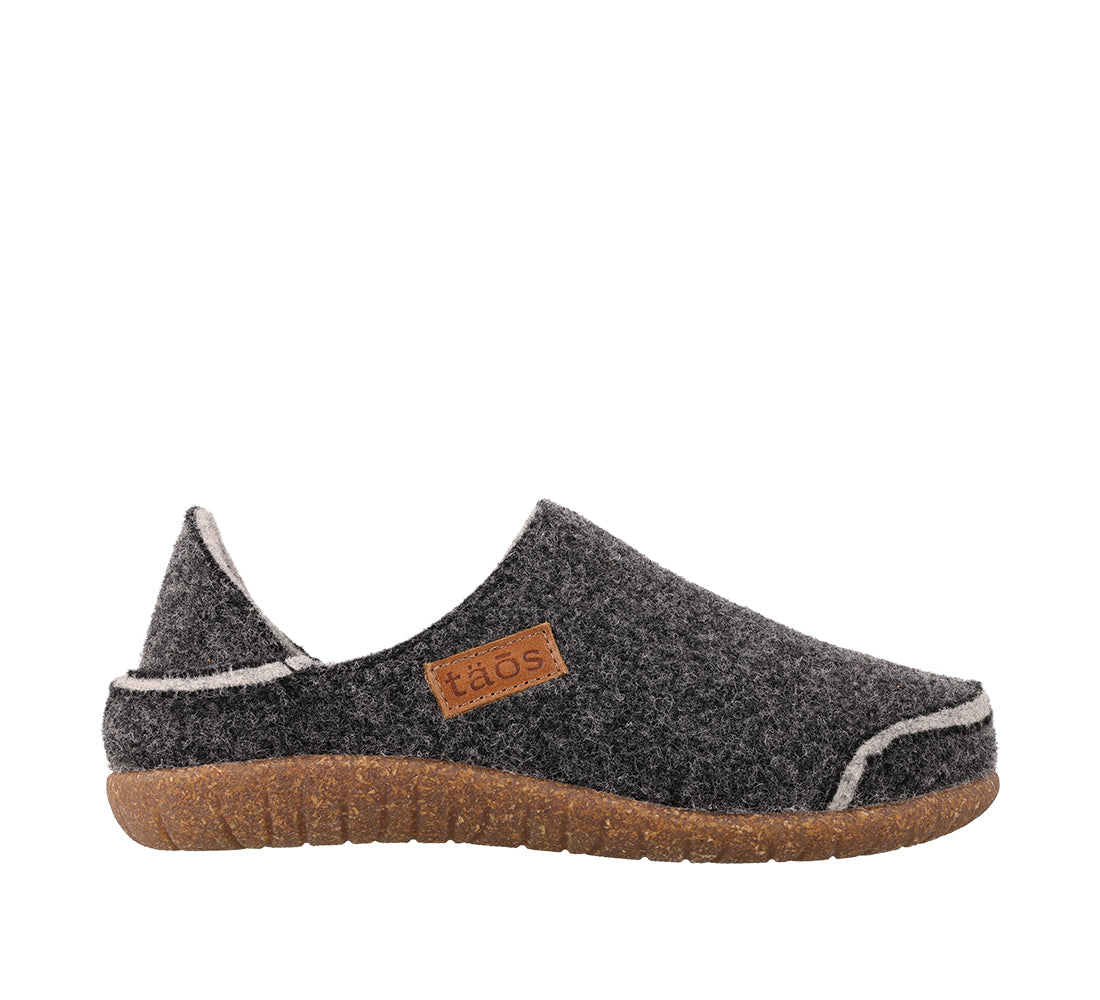 Dark gray slip-on shoe with brown sole on a white background