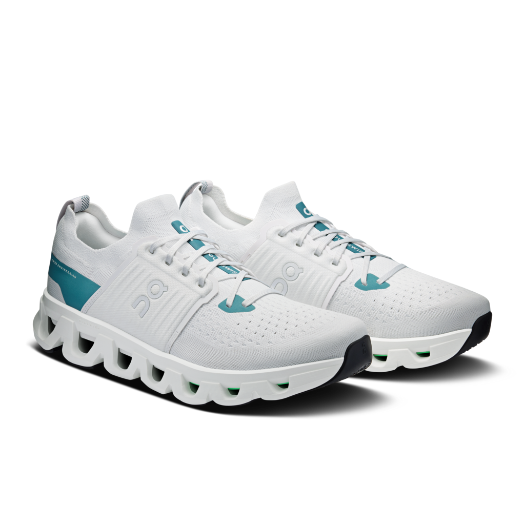 White running shoes with teal accents on a white background