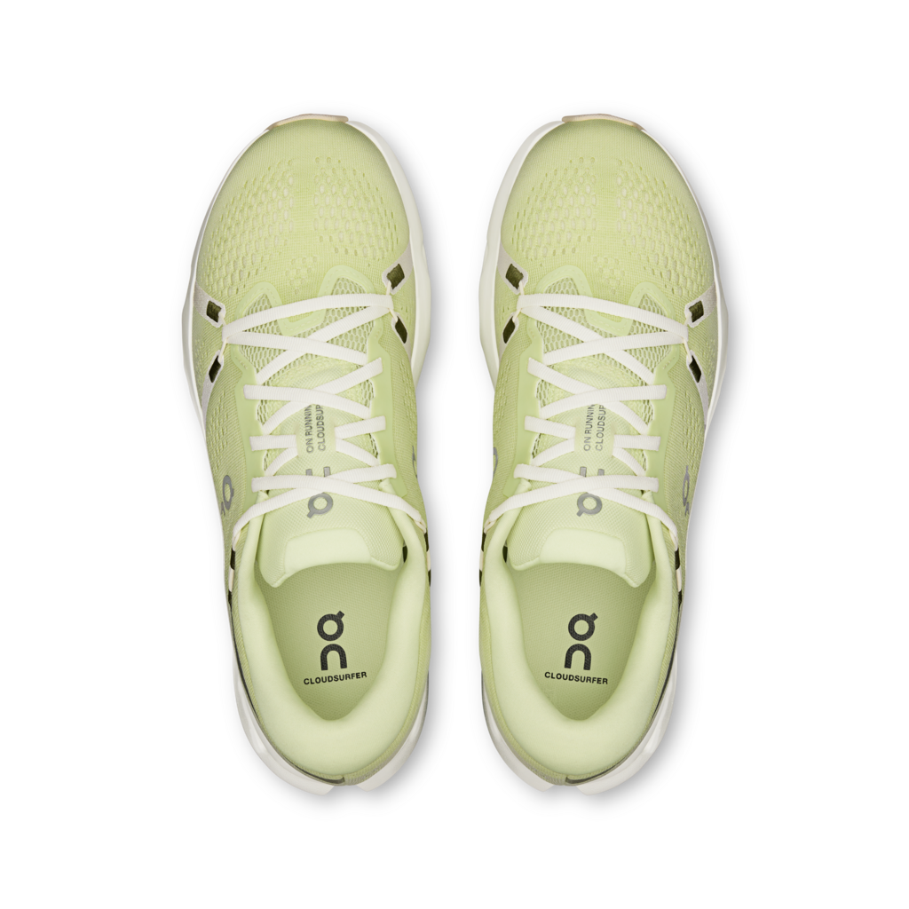 Pair of light green running shoes with white laces on a transparent background