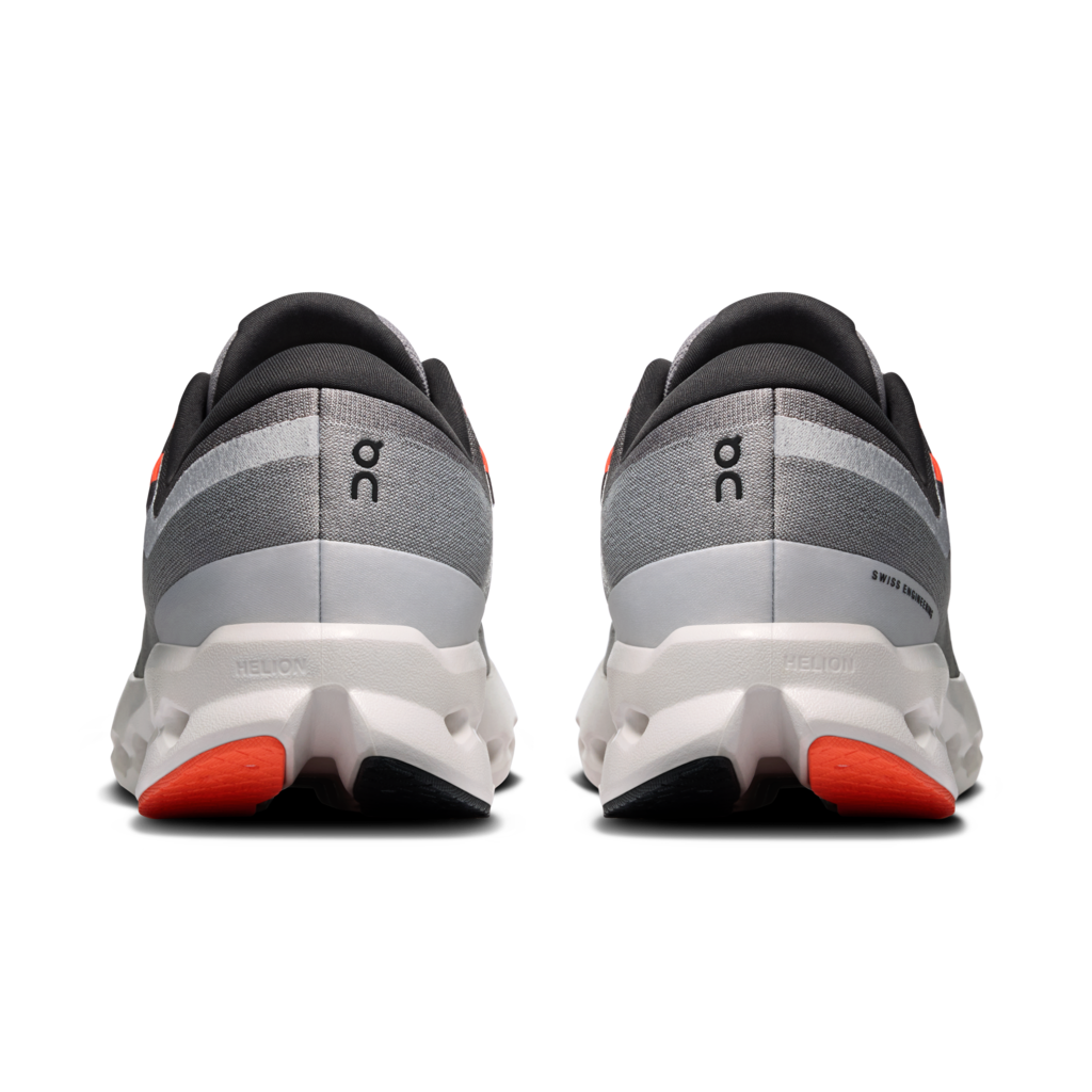 A pair of On running shoes shown from the back, featuring a gray and white textured upper, a white midsole, and bright orange accents on the outsole.
