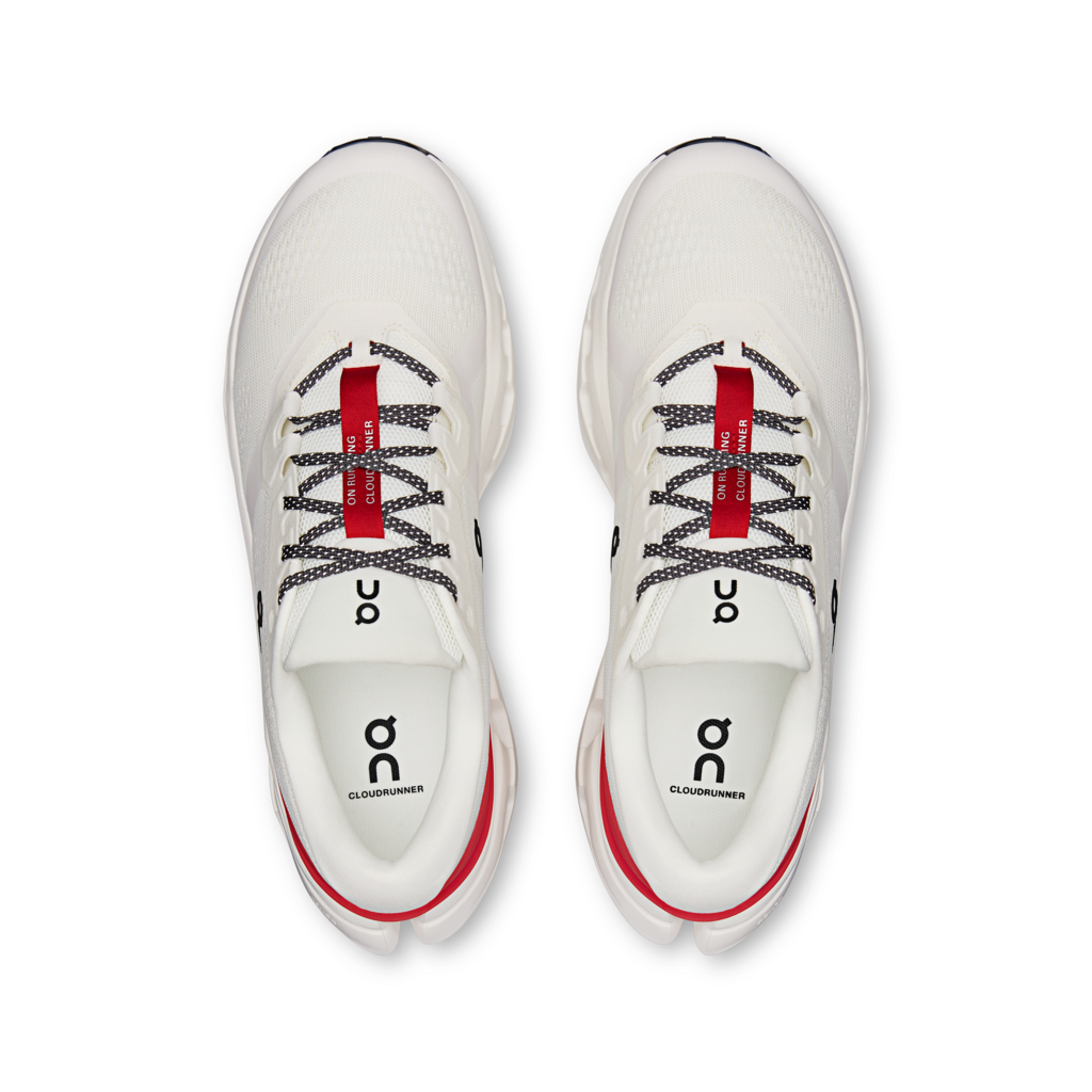 White running shoes with red accents on a white background