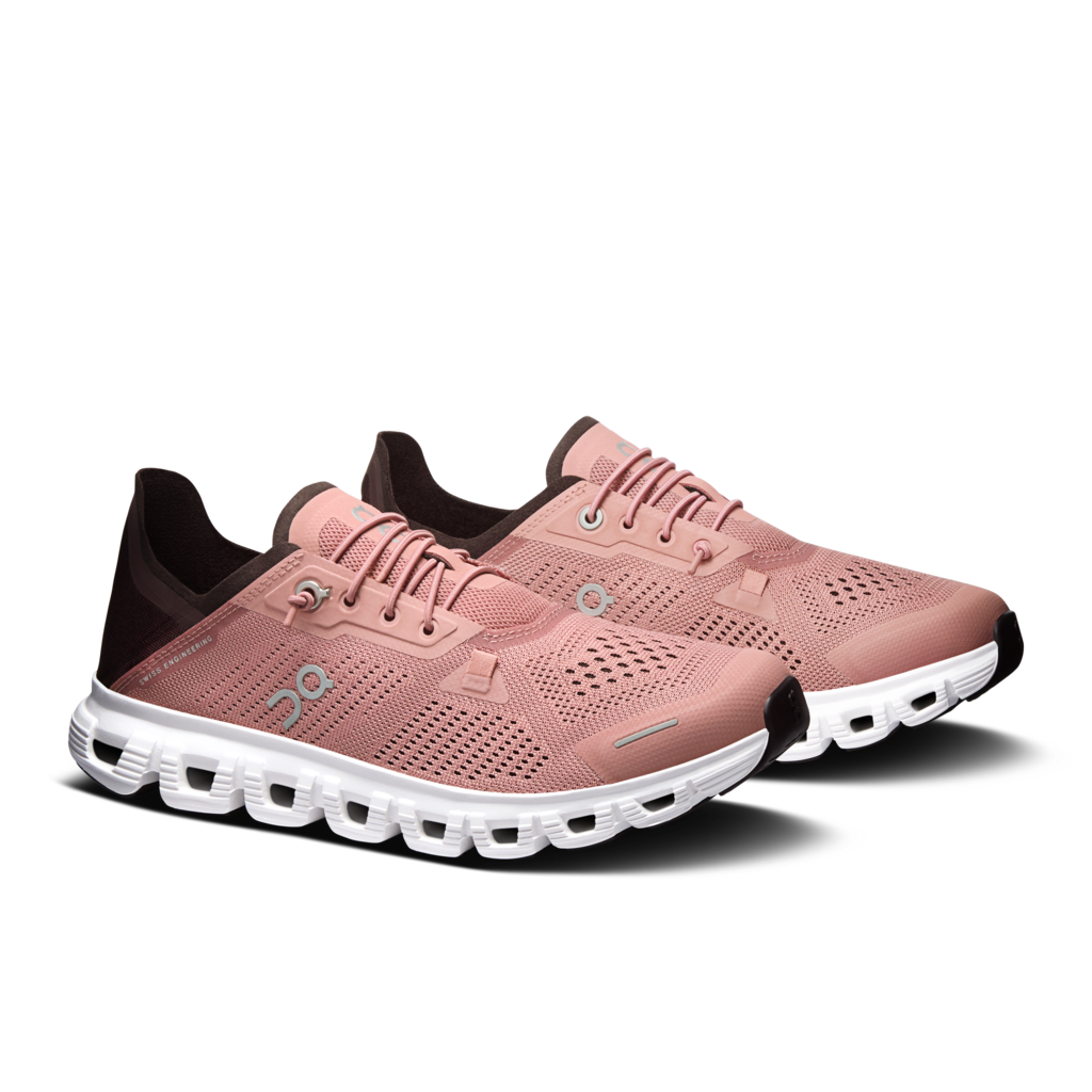 A pair of On running shoes in dusty pink with dark brown accents and a white cushioned sole, shown on a clean white background.
