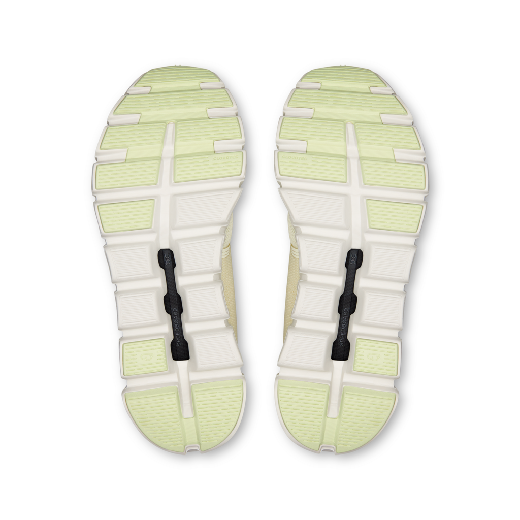 Top view of a pair of shoes with a white sole and green accents on a white background