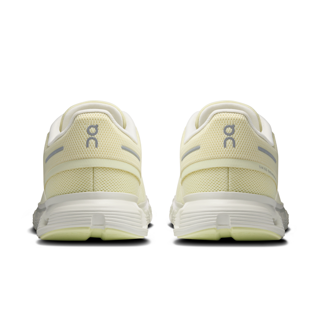 Pair of light-colored running shoes with 'On' branding on a white background