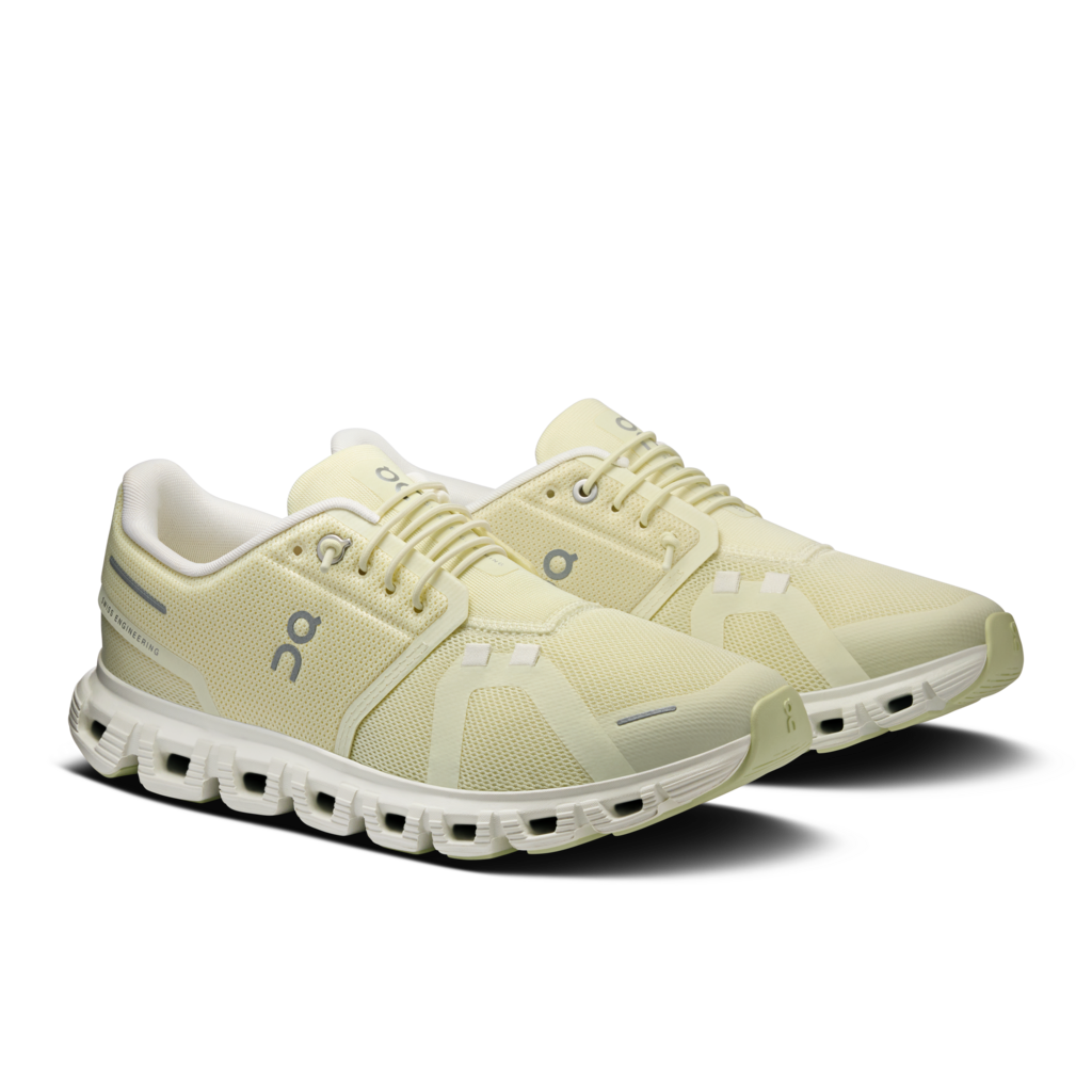 Pair of light-colored running shoes on a white background