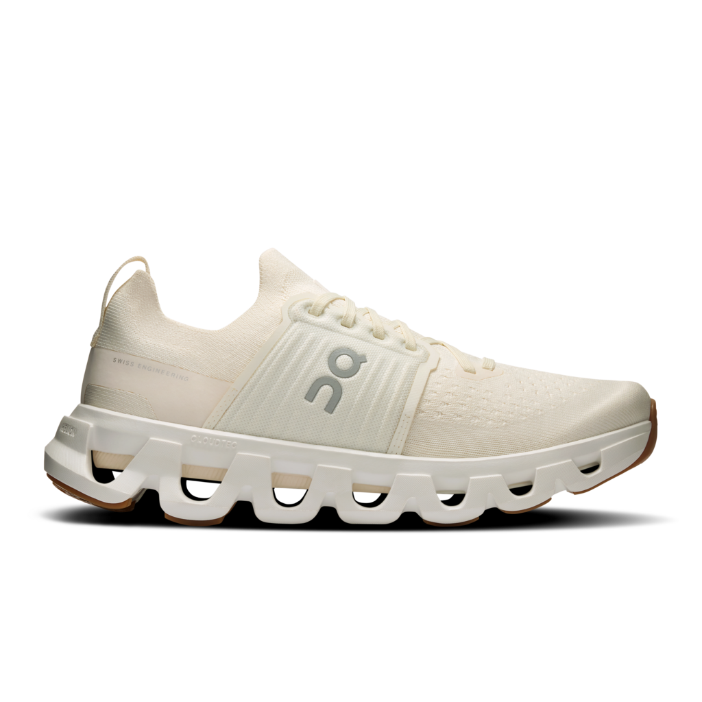 White sneaker with brown accents on a black background