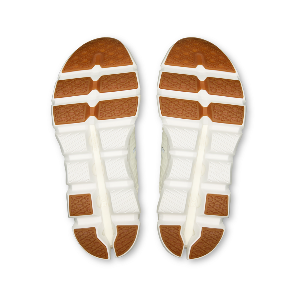 White shoe soles with brown rubber outsoles on a white background