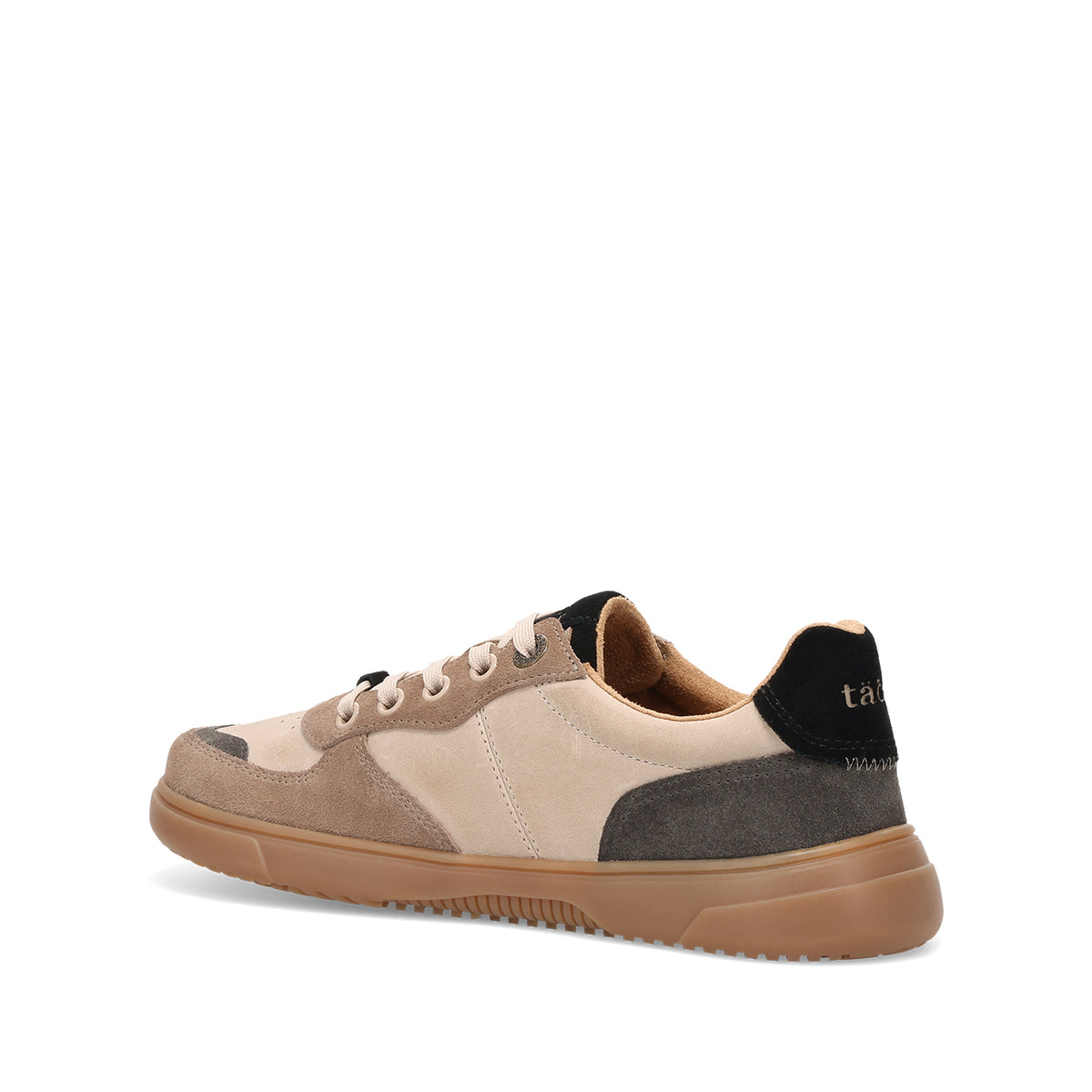 A low-top sneaker shown from a three-quarters rear angle, featuring beige and taupe suede panels, a dark gray side accent, a black heel tab with gold lettering, and a gum brown sole.