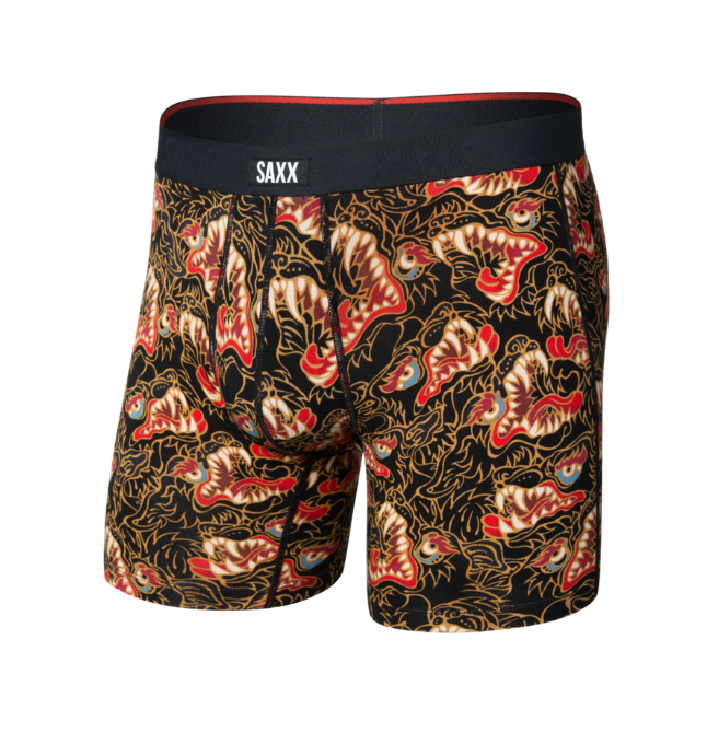 Men's boxer briefs featuring a black background with a detailed red, gold, and beige dragon pattern, complete with a black waistband displaying the white brand name 'SAXX'.