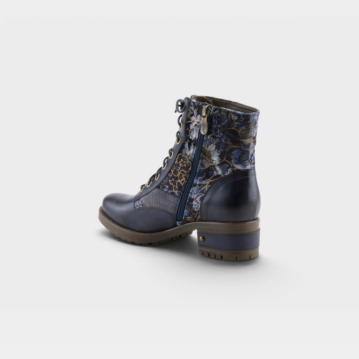 A navy blue lace-up ankle boot with a patterned blue and gold floral side panel, a side zipper, and a chunky brown block heel, shown from a three-quarters rear angle on a light gray background.