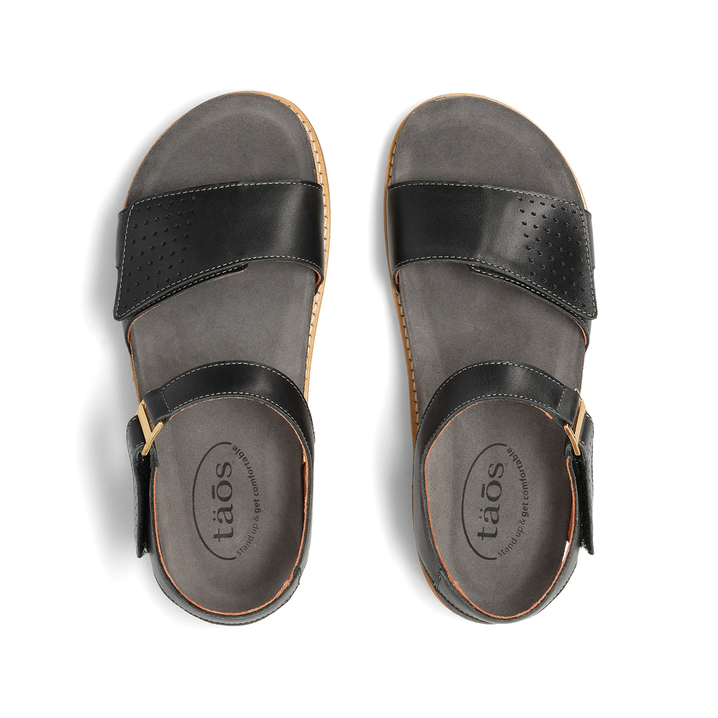Pair of black sandals with 'taos' branding on a white background