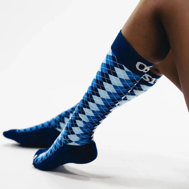 Blue and white argyle patterned socks on a white background
