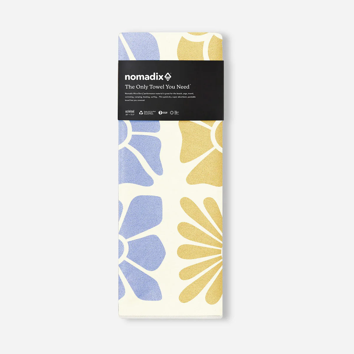 Packaged towel with floral design and 'nomadix' branding on a white background