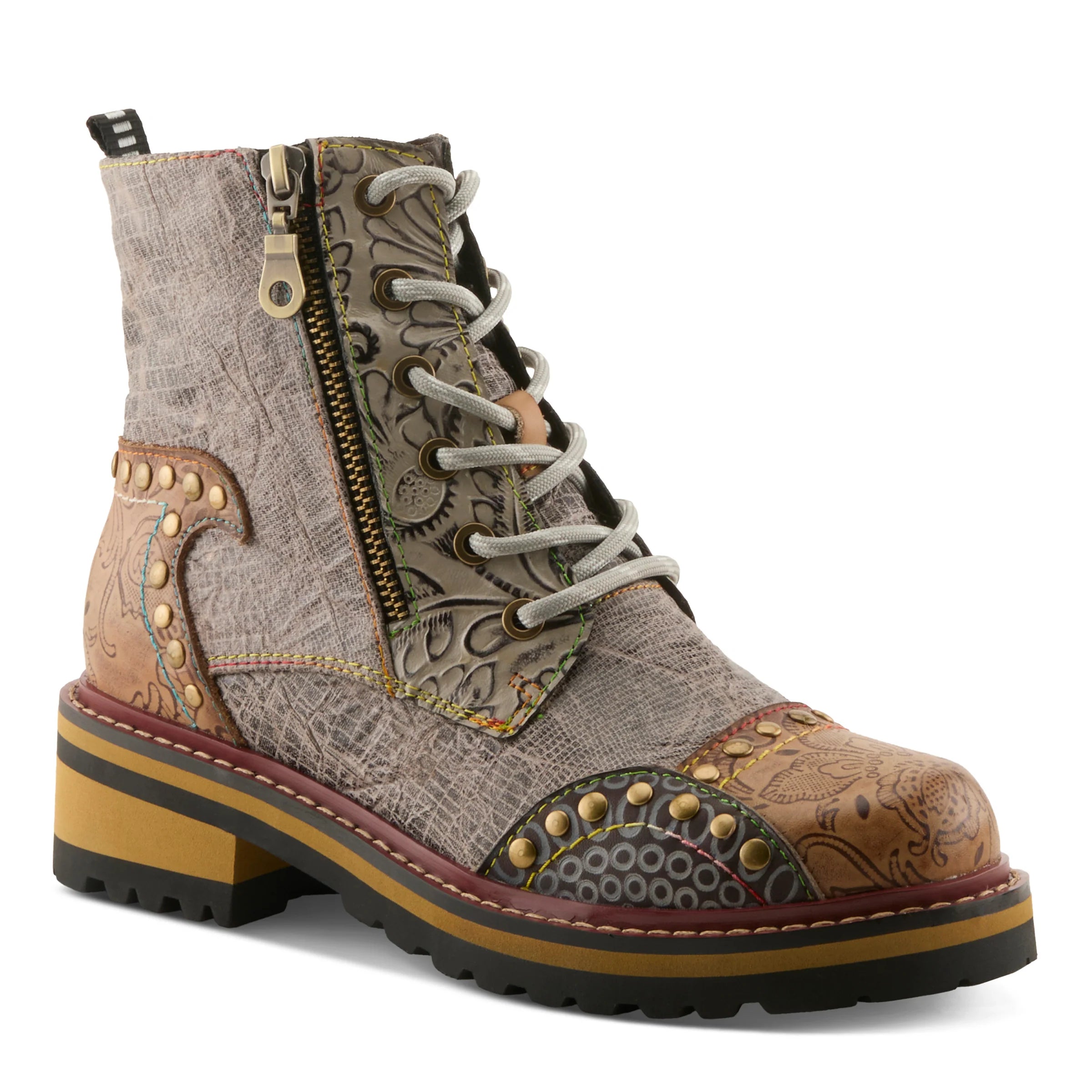 A lace-up ankle boot with a western-inspired patchwork design, featuring textured leather panels, brass studs, a side zipper, and a chunky platform sole.