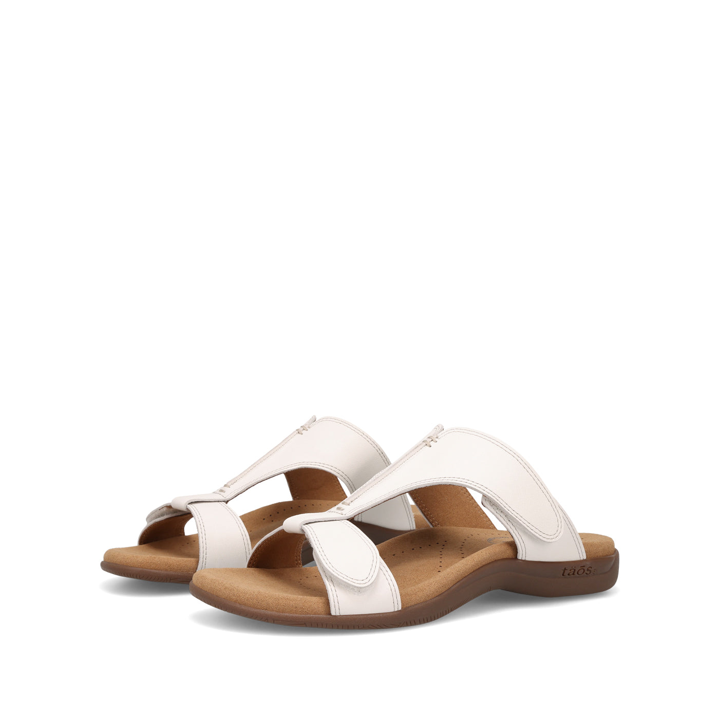 Pair of white sandals with brown soles on a white background