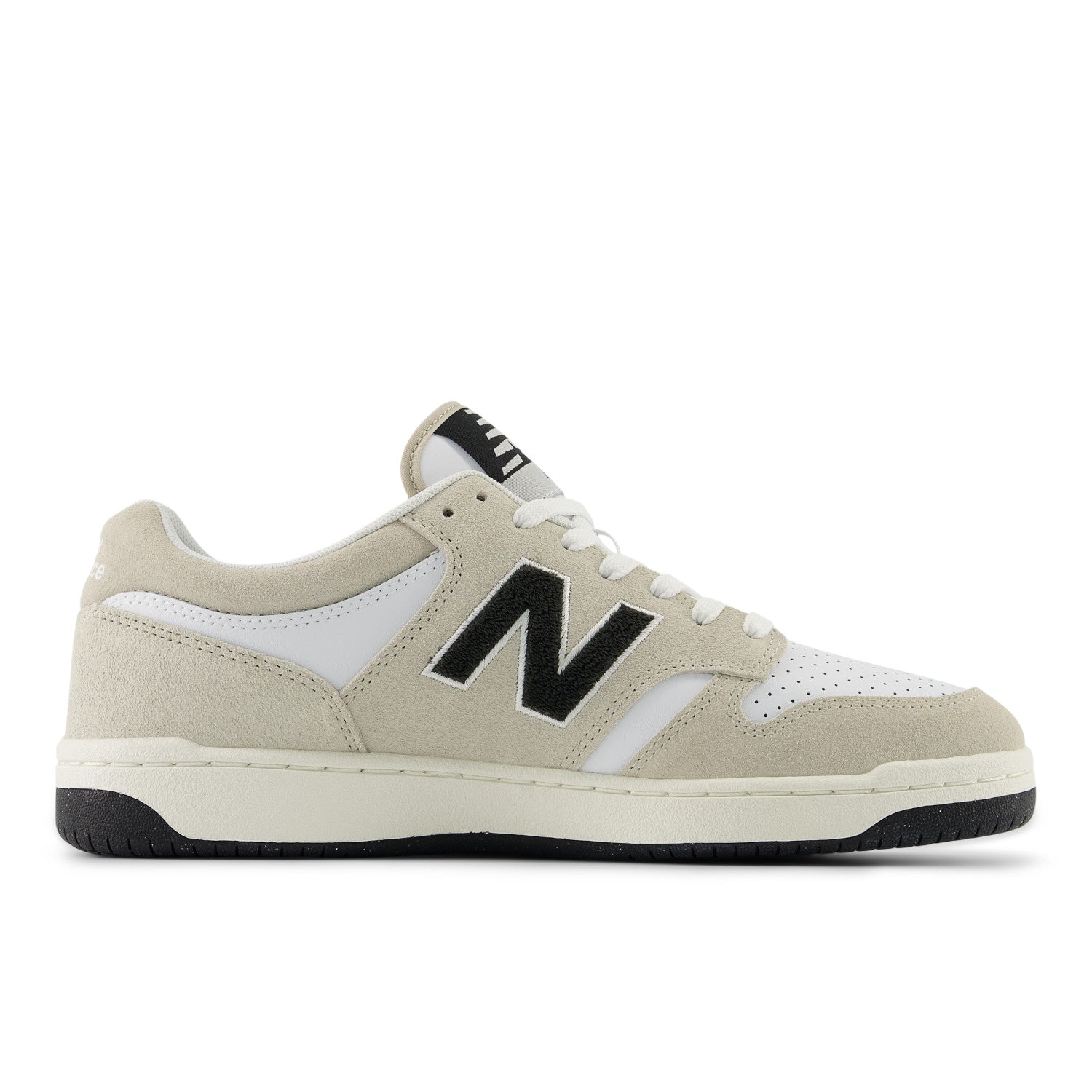Beige sneaker with black 'N' logo on a white background