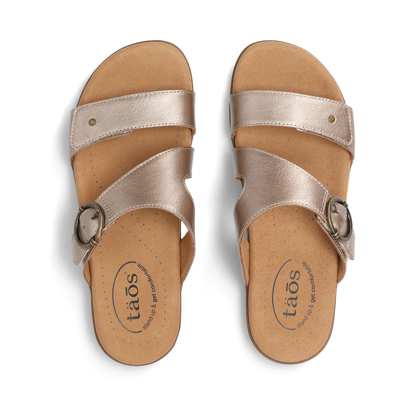 Pair of tan sandals with metallic straps on a white background
