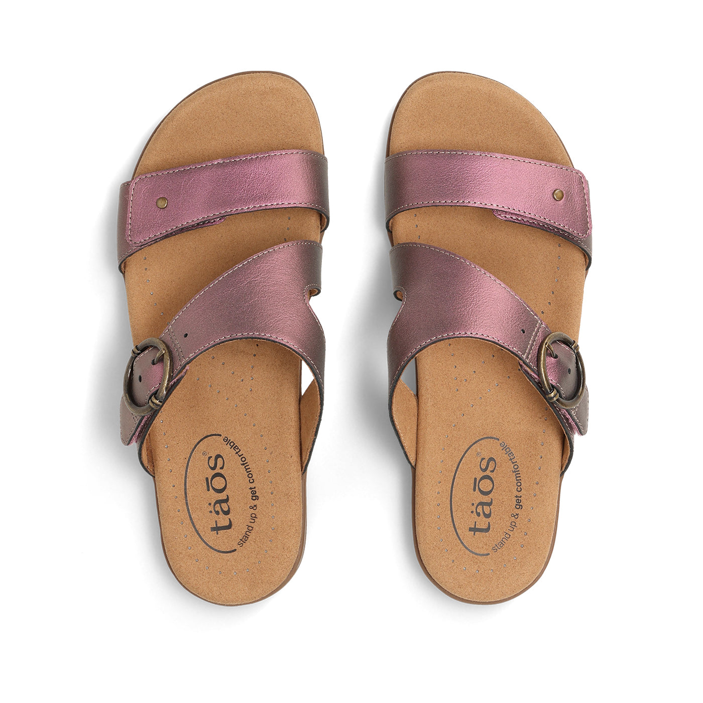 Pair of pink sandals with brown soles on a white background