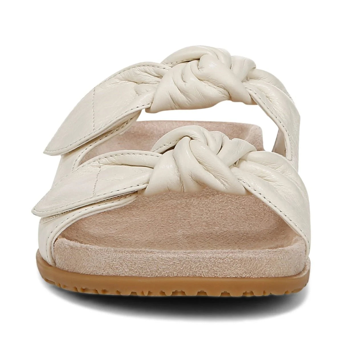 White sandal with braided design on a white background