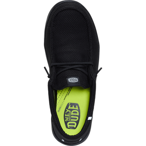 Black shoe with a bright green sole on a transparent background
