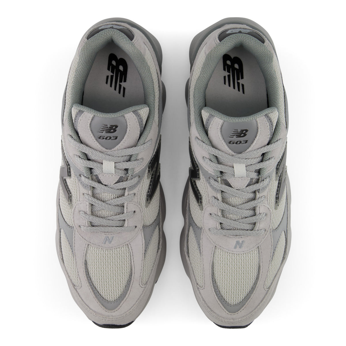 A pair of New Balance 603 sneakers in a light gray colorway, shown from a top-down view on a white background.