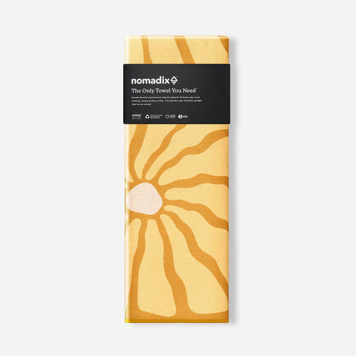 Packaged towel with sunburst design and 'nomadix' branding on a white background