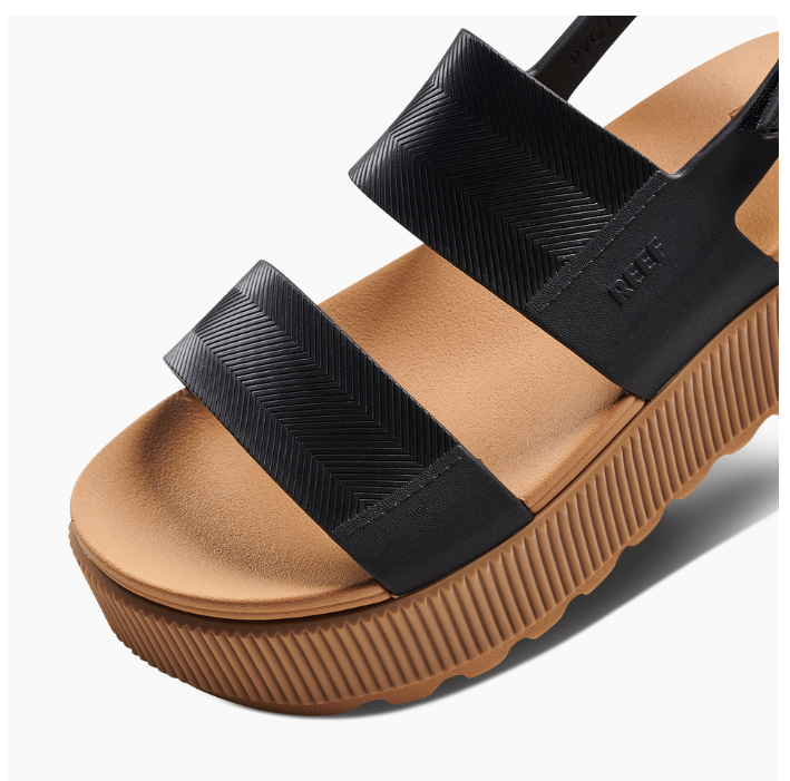 Brown sandal with black straps on a white background