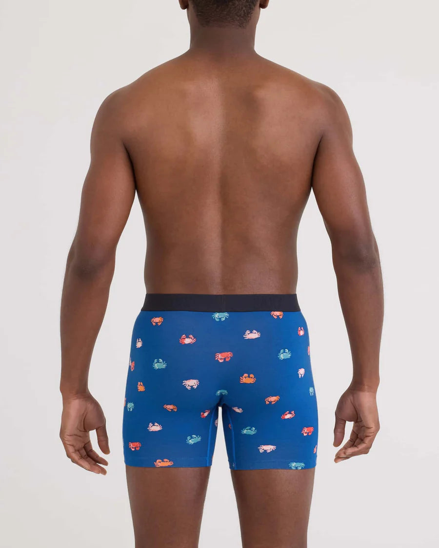 Man wearing blue boxer briefs with colorful car pattern on a white background