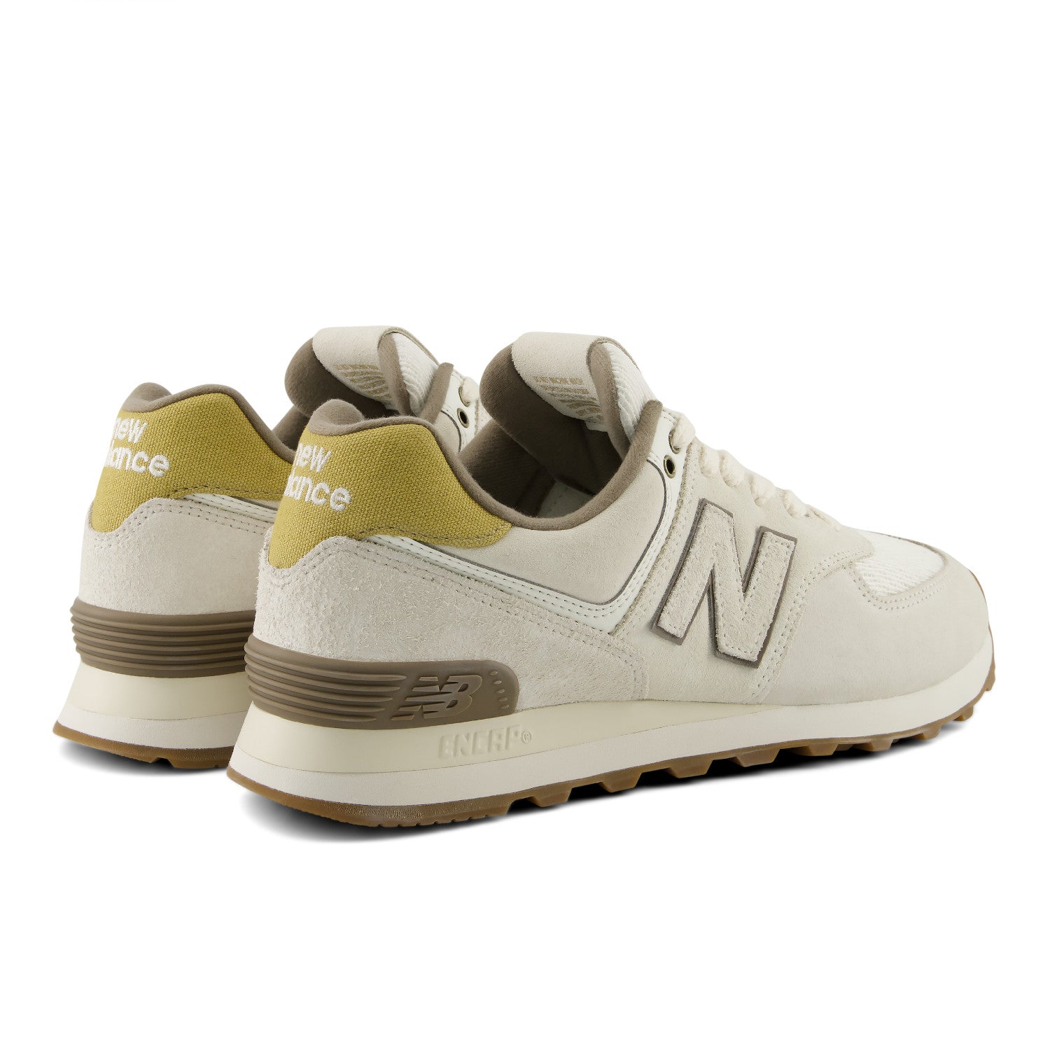 Beige New Balance sneakers with green accents on a white background