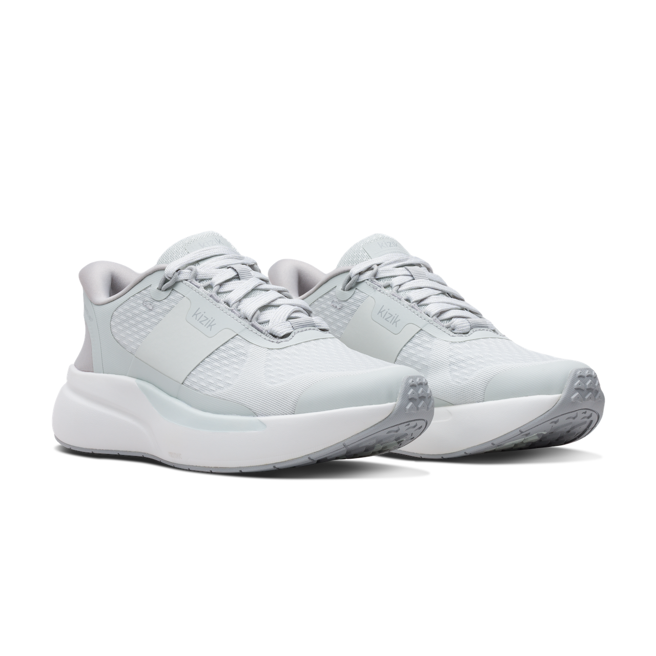 Pair of light gray athletic shoes on a white background