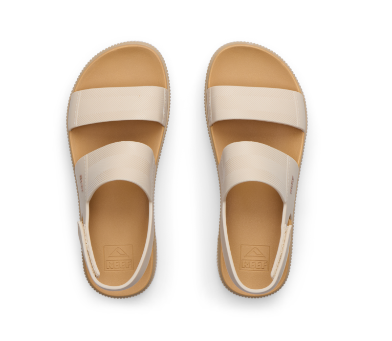 Pair of beige sandals on a white background