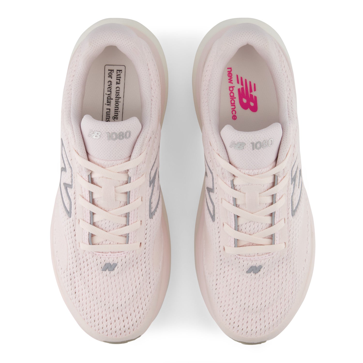 Pair of light pink New Balance sneakers on a white background