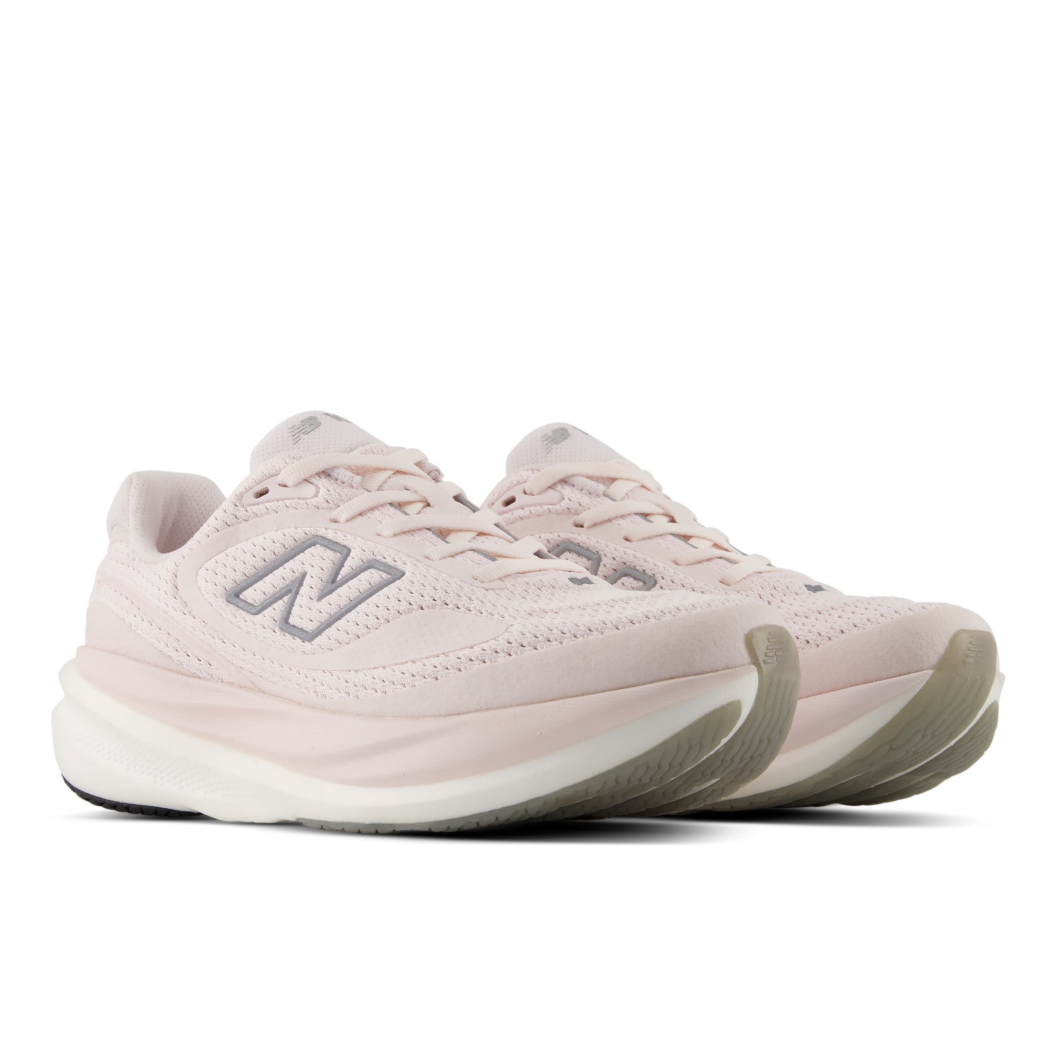 Pair of light pink New Balance sneakers on a white background
