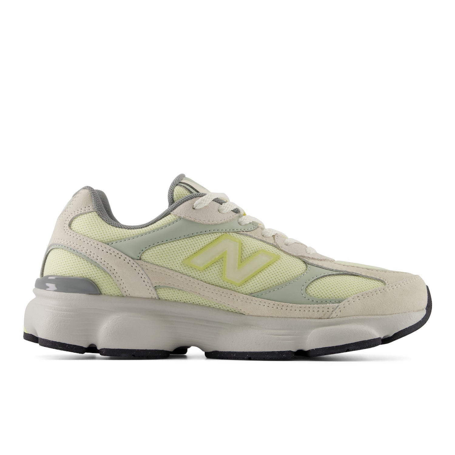 Beige and green sneaker with New Balance logo on a white background