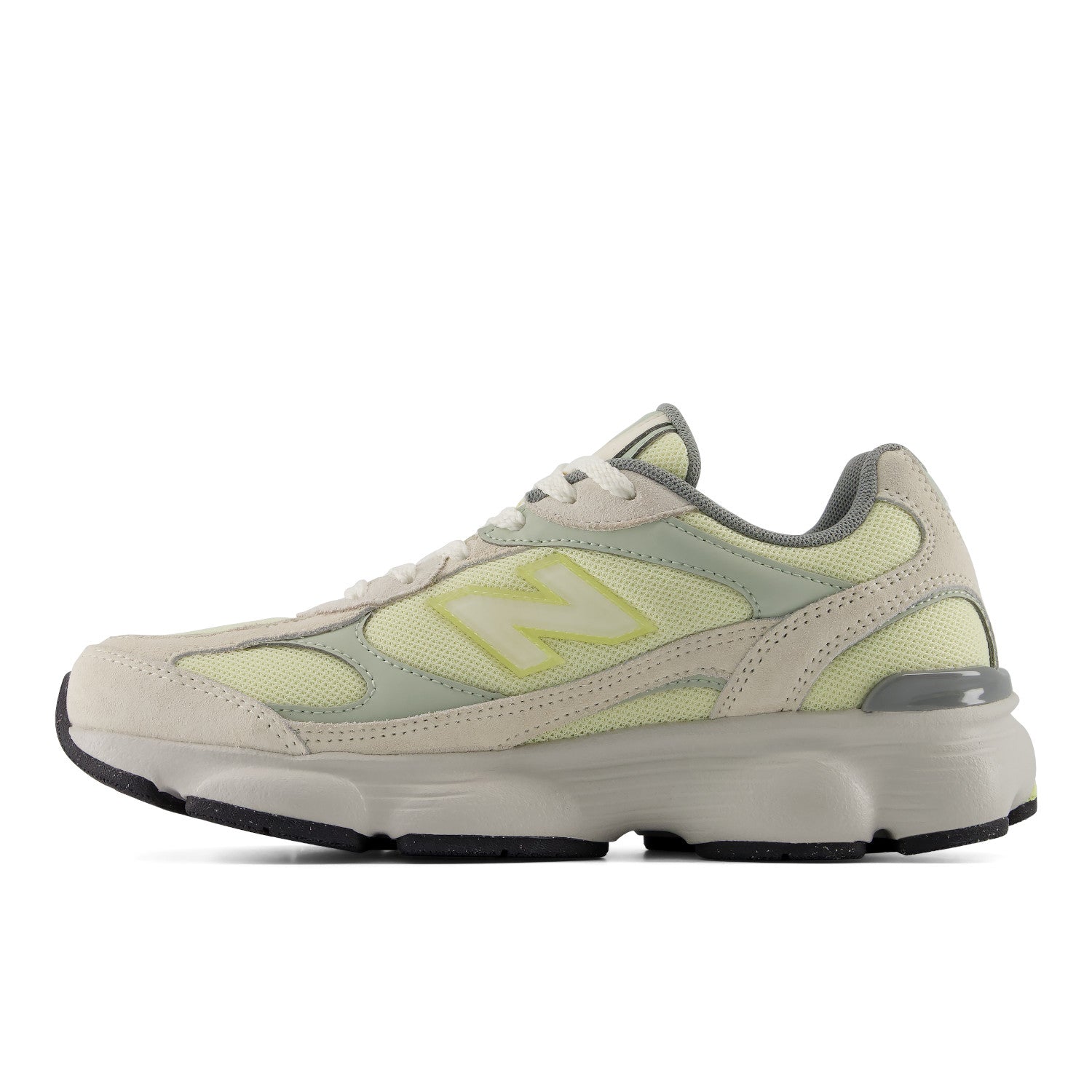 Light gray and green sneaker with New Balance logo on a white background